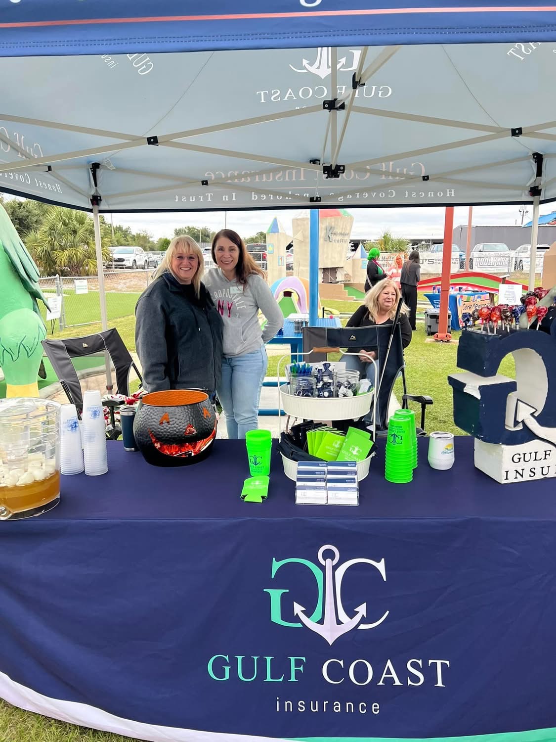 Gulf Coast Insurance team at their hole with a cauldron of candy