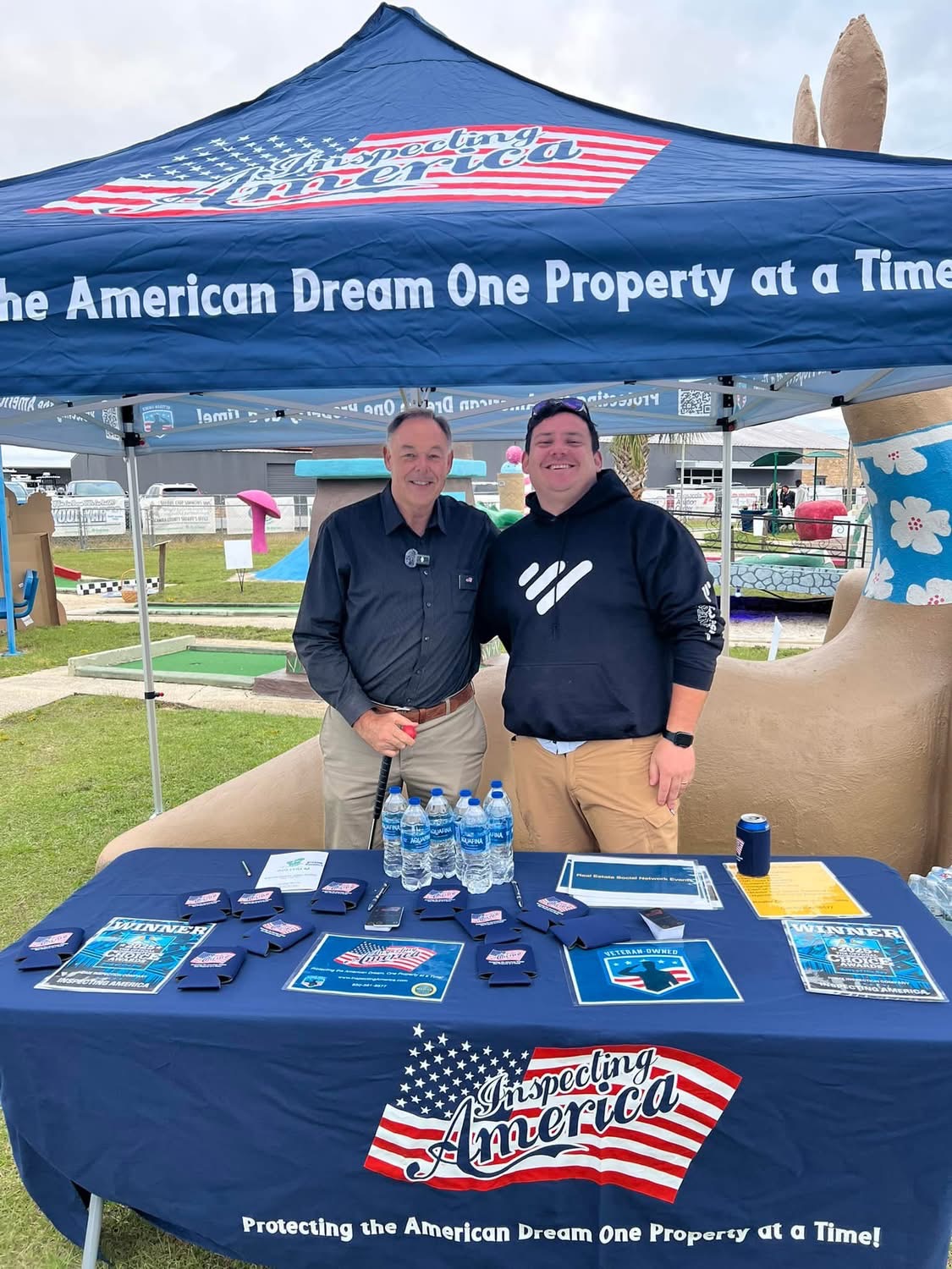 Inspecting America sponsor tent with giveaways and putters
