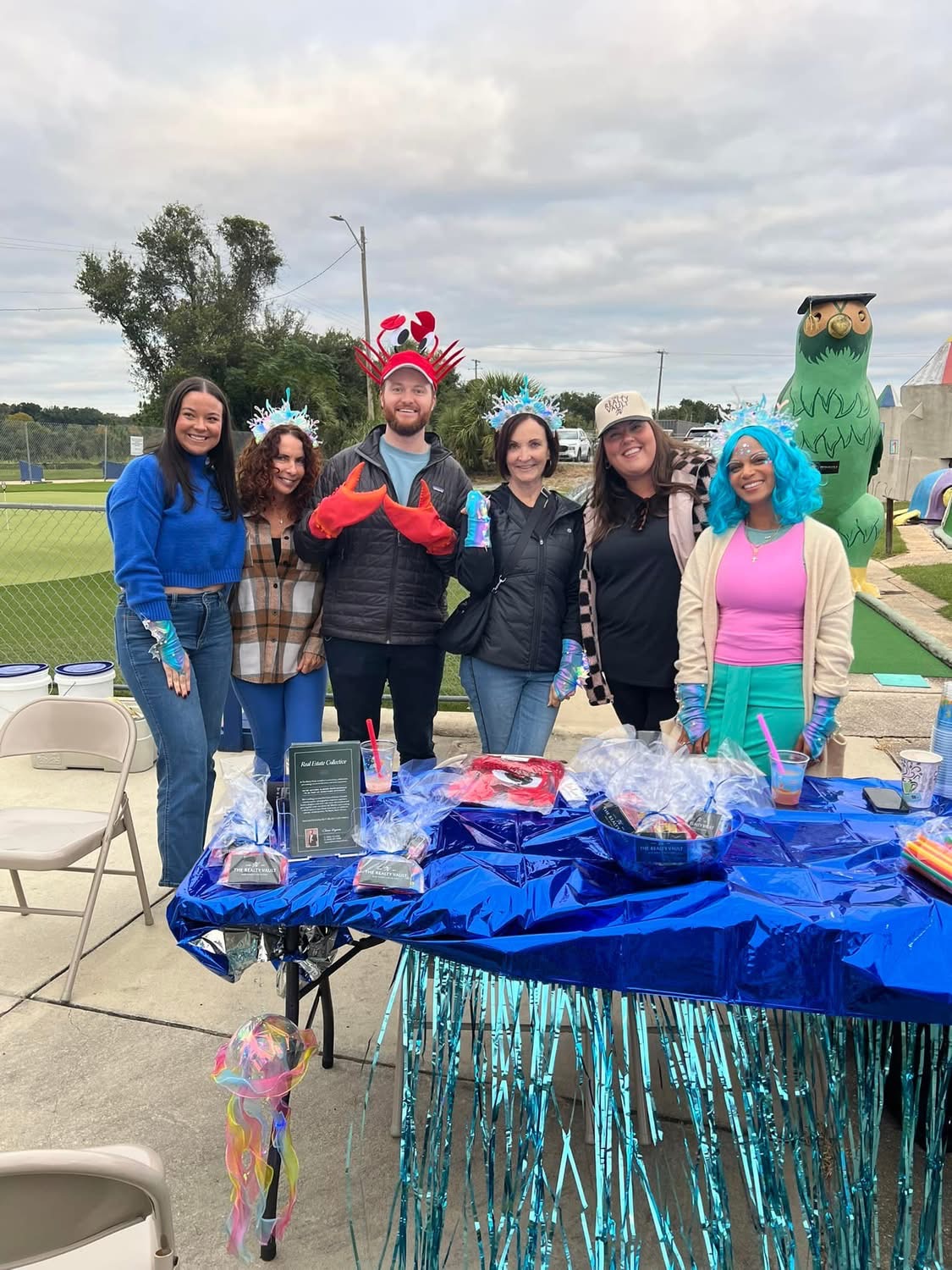 Team in sea-creature headpieces and a blue wig at the Realty Vault hole