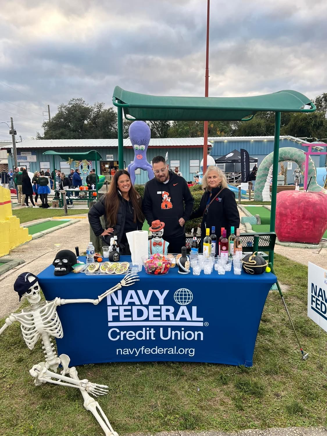 Navy Federal Credit Union hole with a skeleton and drinks table