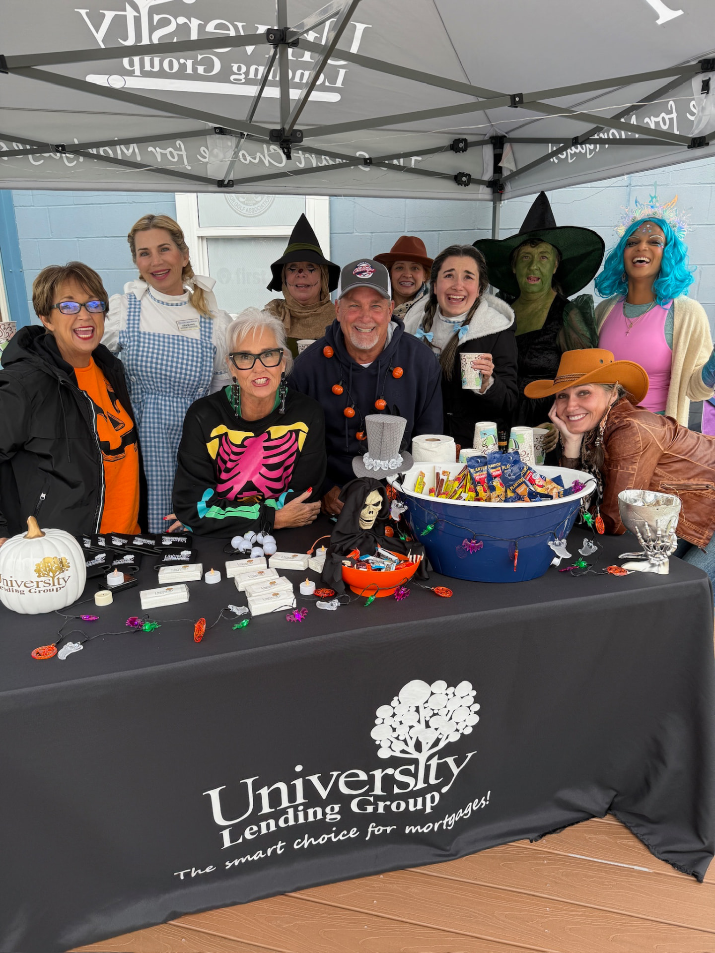 Large group of costumed guests at the University Lending Group sponsor tent